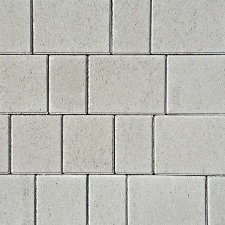 A grid-like geometric pattern of light gray Barleystone 60mm Castlepave Smooth Birch pavers, combining rectangular and square shapes. They create an orderly look with subtle texture and shading variations, reminiscent of birch wood.