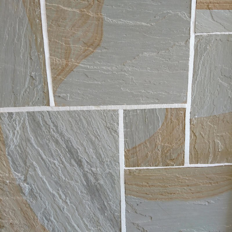 Close-up of a Strata 22mm Calibrated Sandstone GLENDALE wall, showcasing irregular rectangular tiles in muted gray and light brown tones. The sandstone's natural texture and subtle variations are highlighted by white grout lines.