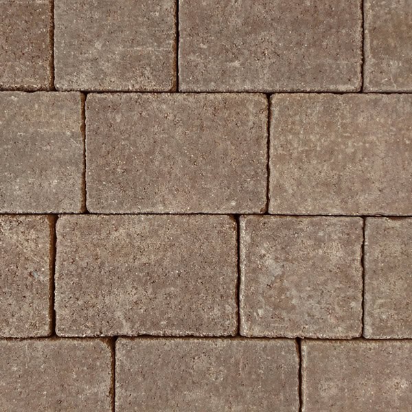 A close-up of Barleystone Kingspave Cobble Juniper reveals square, textured tiles in earthy tones arranged in a grid. The rough surface and subtle color variations give it a rustic, aged masonry look.