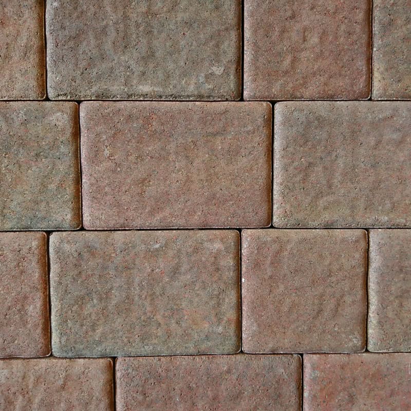 A close-up of a Barleystone 50mm Ashford Juniper brick wall reveals its textured, weathered look. The rectangular bricks are laid in a staggered pattern, showcasing different brown tones with subtle red hints.