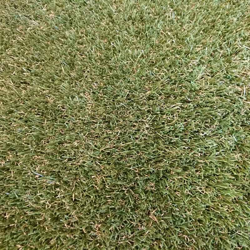 Close-up of 25mm Tri-Colour Artificial Grass with Spring-back technology reveals dense, uniform green blades and occasional brown strands for a natural look.