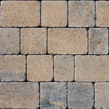 A close-up view of Barleystone Kingspave Cobble Walnut surface shows square stone tiles in a staggered pattern, varying in color from light beige to gray with a touch of walnut, highlighting slight texture and wear.