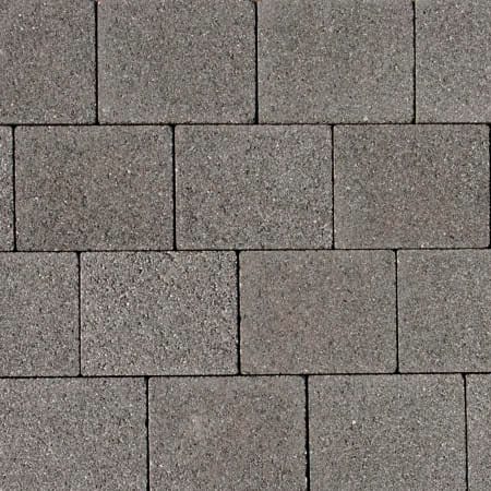 A close-up of a pavement pattern featuring Barleystone 60mm Granite Paving Black arranged in a staggered brick-like design. The textured surface with subtle color variations suggests a utilitarian and durable outdoor walkway option.