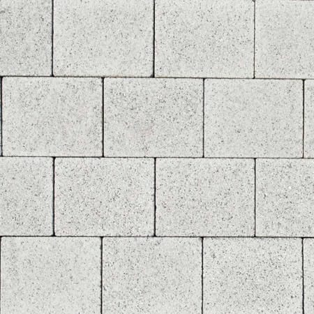 Close-up of Barleystone 60mm Granite Paving Grey bricks in a staggered pattern. The slightly rough texture creates a uniform and structured look.