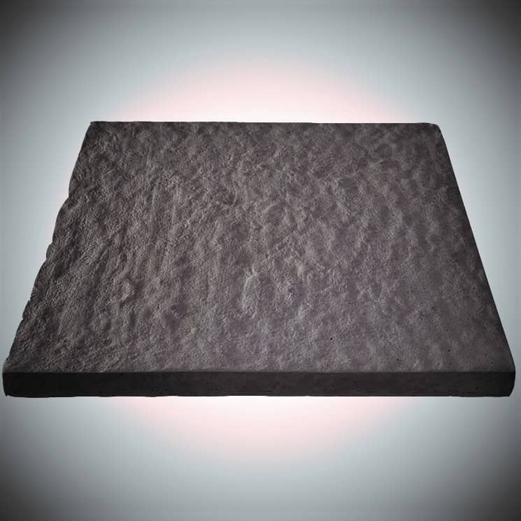 A dark Brett Stamford Ultra Ripple Slab in charcoal is centrally placed against a gradient light gray background, forming a subtle halo effect.