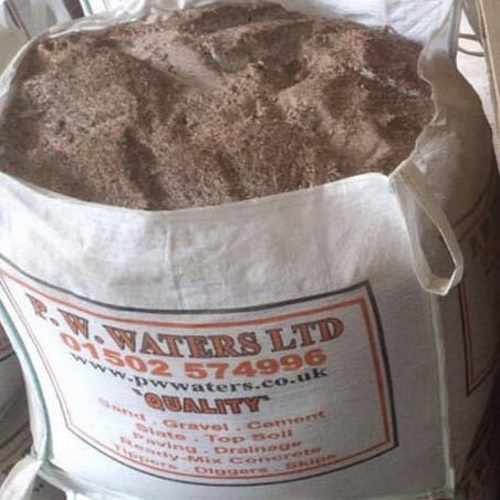 A large white industrial bulk bag of rock salt labeled 