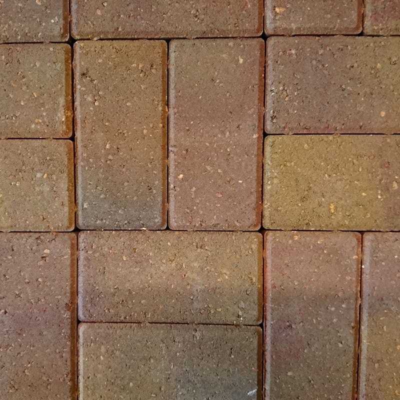 Close-up of the Breedon 50mm Drive Sunset tiles, forming a sunset-like glow with sandy texture and slight color variations, laid precisely in a grid with narrow gaps.