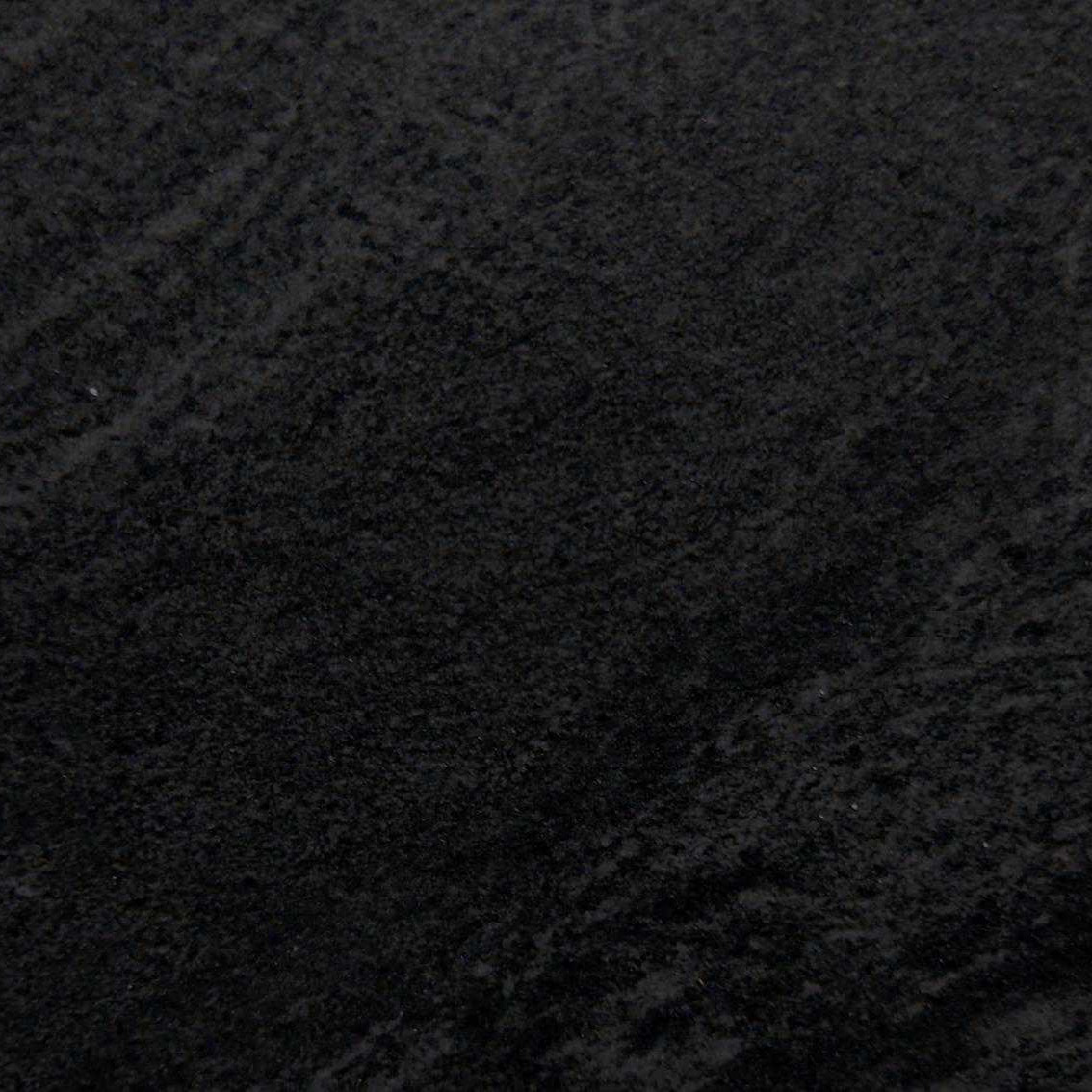 A detailed look at the Premier Cathedral Anthracite Porcelain 900x600x20mm reveals a surface with subtle shading variations and a texture resembling natural stone or fabric, featuring slight swirls and lines.