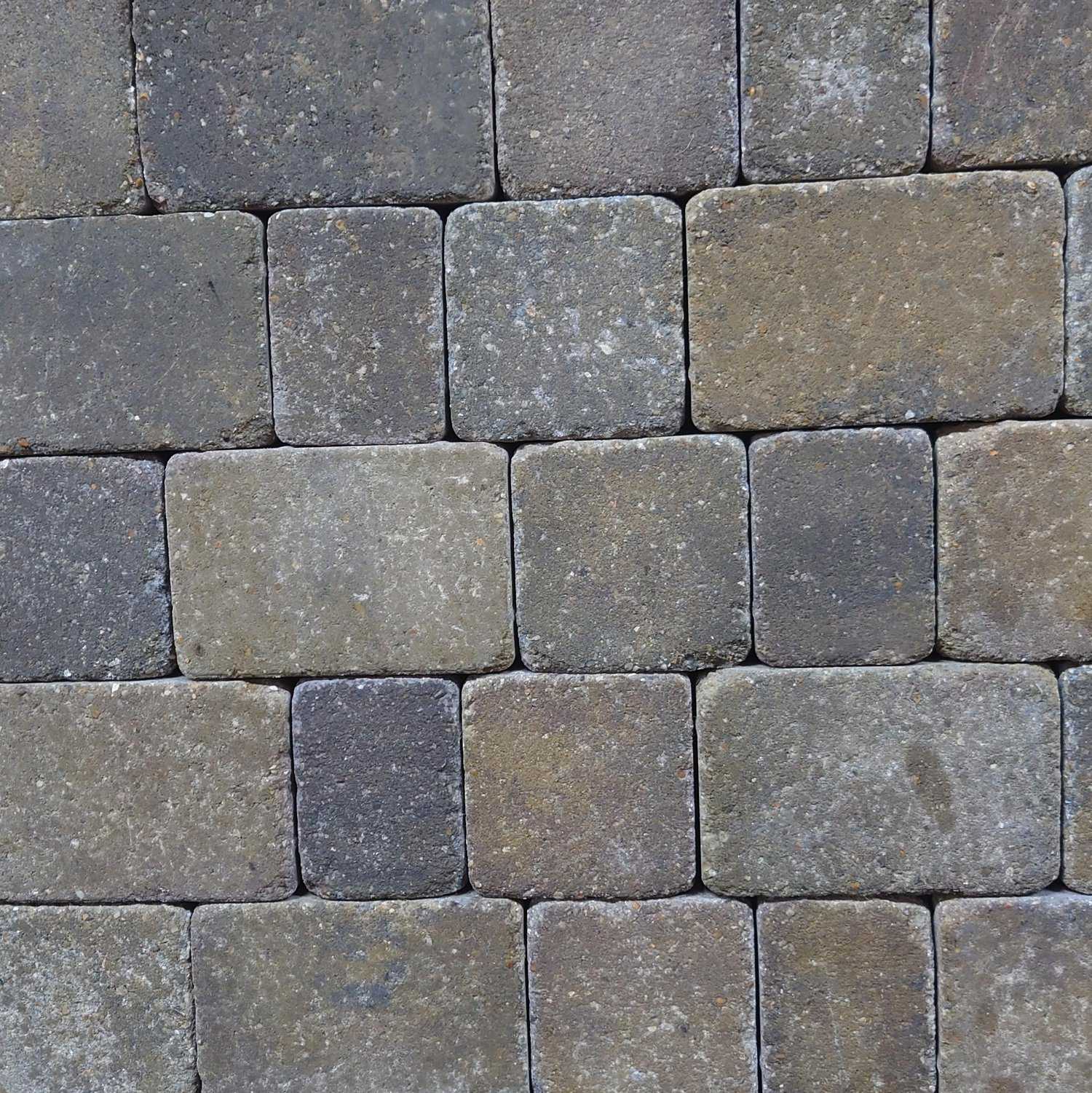 Close-up of Breedon 50mm Norfolk Rumbled Harvest Setts, showcasing a weathered pattern. The rectangular cobblestones vary in gray and brown shades, offering a rustic texture reminiscent of classic pathways.