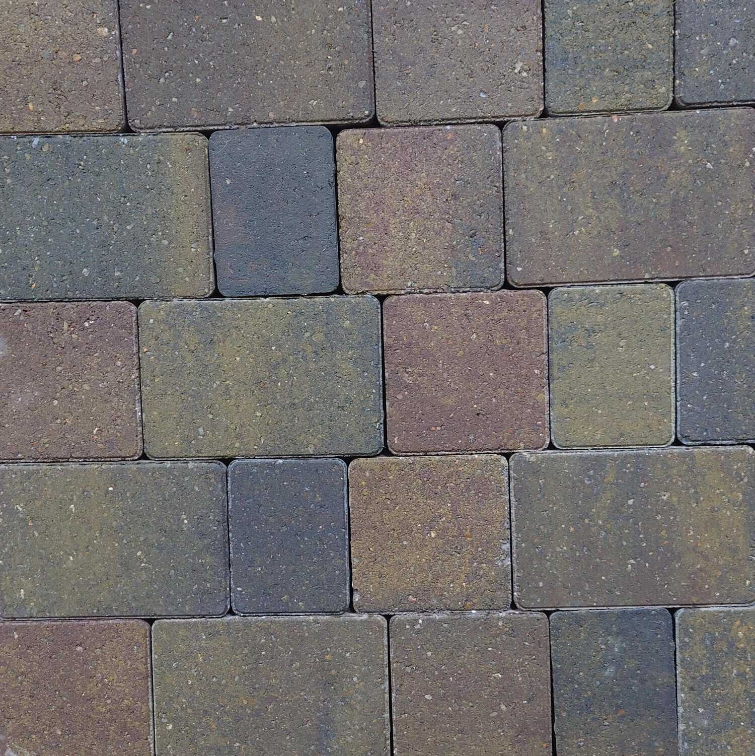 A close-up view of a Breedon 50mm Suffolk Smooth Harvest Setts wall shows a staggered pattern, with bricks in brown, green, and gray shades for a textured and rustic look.