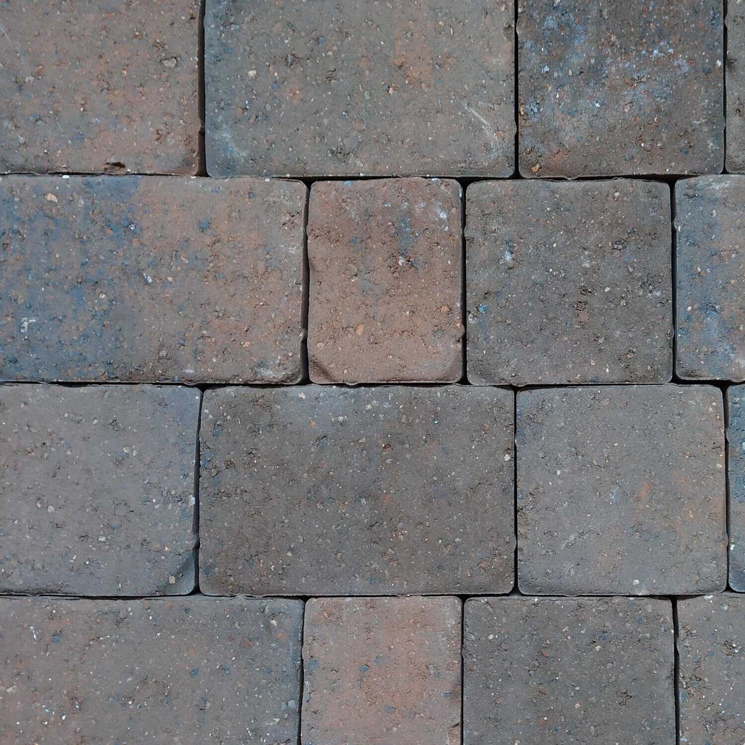 A close-up of a wall made with Cemex 50mm ReadyPave CAMDEN Autumn Hue bricks shows a staggered arrangement featuring varying brown shades, subtle blue speckles, and natural textures typical of stone.