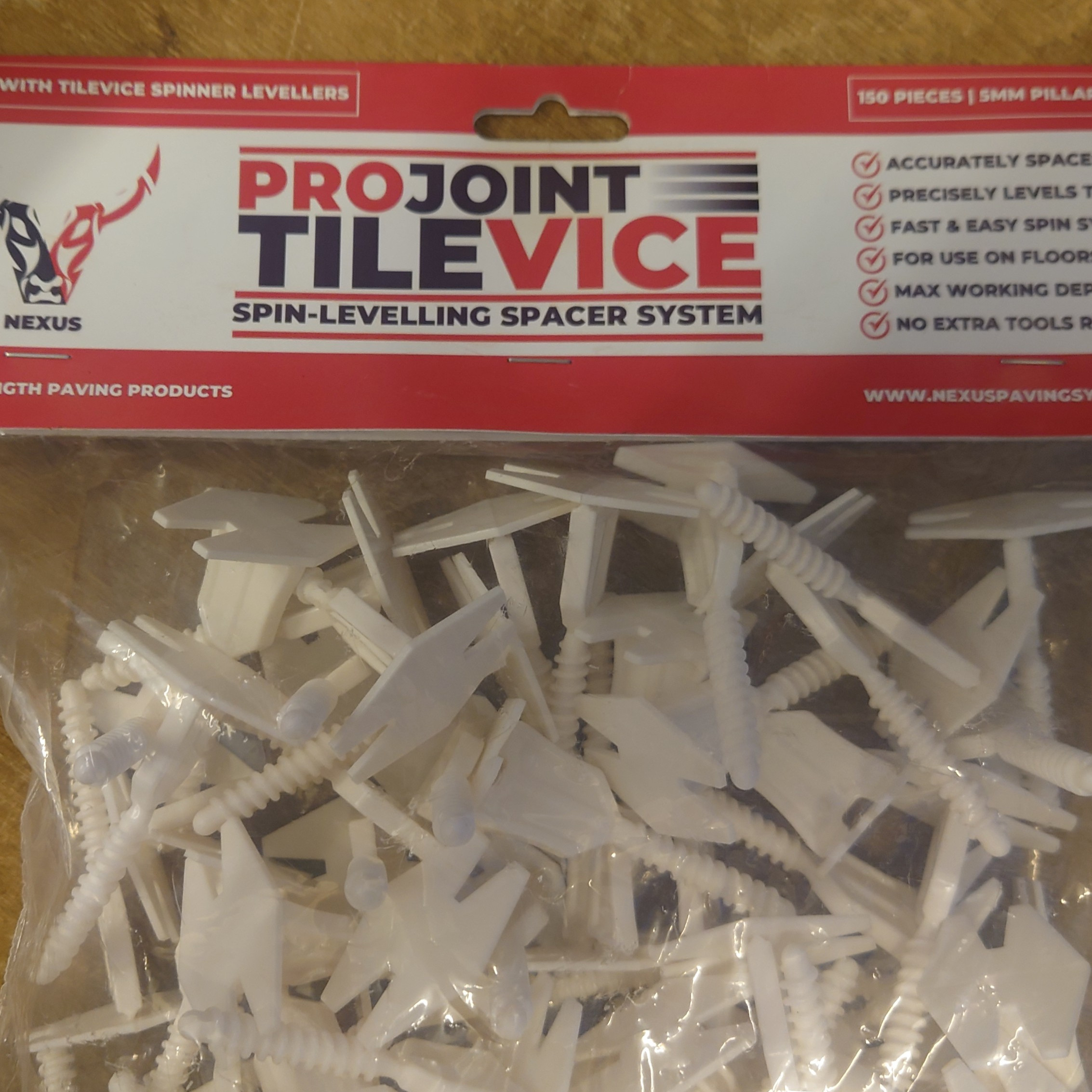 The ProJoint Porcelain Tile Vice Spacer includes 150 white plastic spacer tools for precise tile leveling. It's ideal for porcelain flooring and wall tiling, emphasizing ease of use.